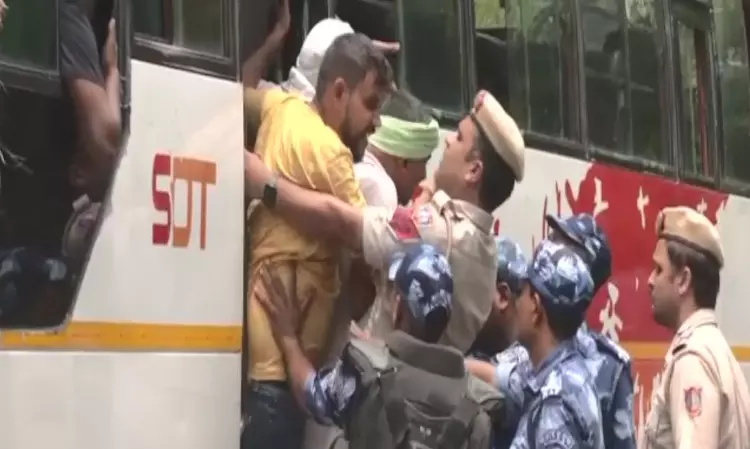Security personnel detains protesting wrestlers as they move towards new Parl