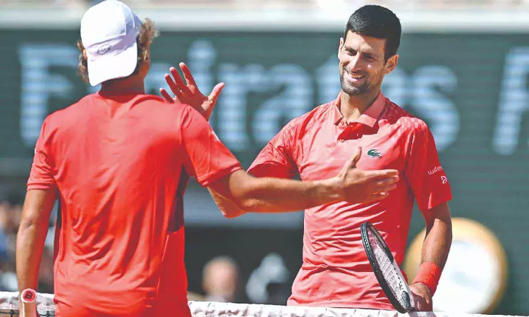 Djokovic canters into French Open round two