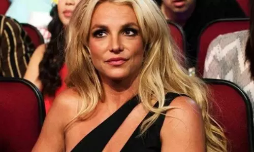 Britney flaunts her new snake tattoo following split from Ashgari