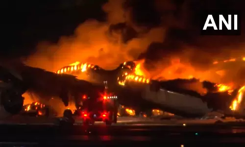 Plane catches fire on runway at Japans Haneda airport, passengers reported safe