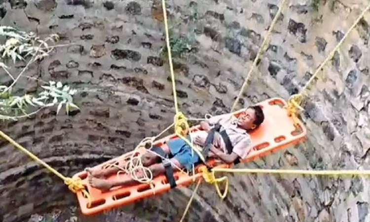 Fire personnel rescue boy from 30-foot well