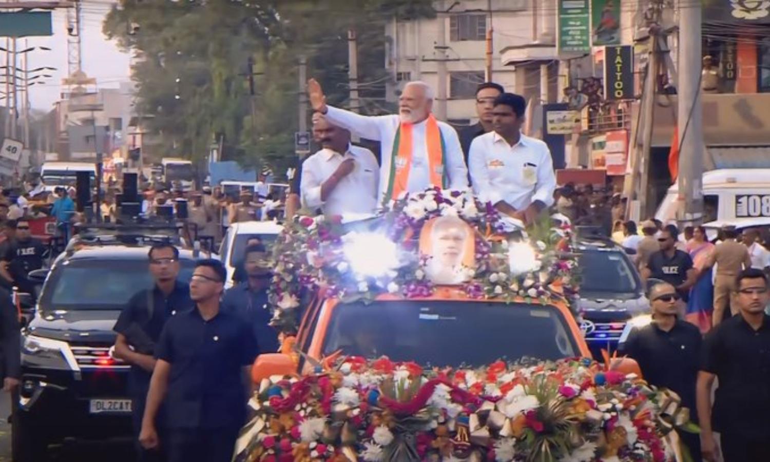 As Modi began his roadshow in an open vehicle,... ... PM Roadshow in Coimbatore live: BJP party-men chant slogans hailing Modi