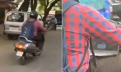 Bengaluru Police reacts to video of man working on laptop while driving scooter