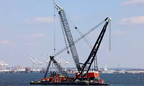 Massive crane put in place to clear Baltimore bridge debris as crews assess damage