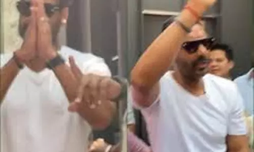 Ajay Devgn greets fans with a namaste outside his residence in Mumbai on 55th bday