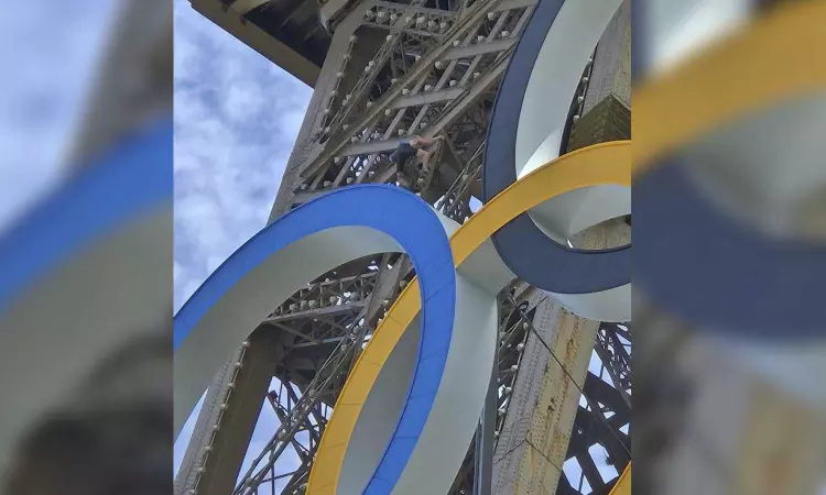 A man is seen climbing the Eiffel Tower, prompting an evacuation hours before closing ceremony A man is seen climbing the Eiffel Tower, prompting an evacuation hours before closing ceremony