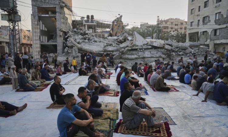 Gaza marks start of Eid with outdoor prayers amongst rubble with food growing ever scarcer
