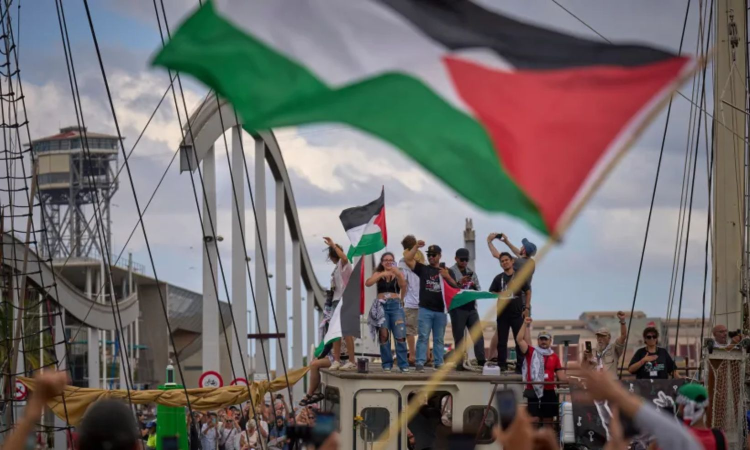 Storm forces flotilla back to Barcelona port, delaying its journey to Gaza Storm forces flotilla back to Barcelona port, delaying its journey to Gaza