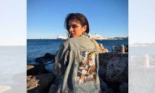 After director Maruthi, actress Malavika Mohanan now sports outfit bearing The Raja Saab poster in Greece