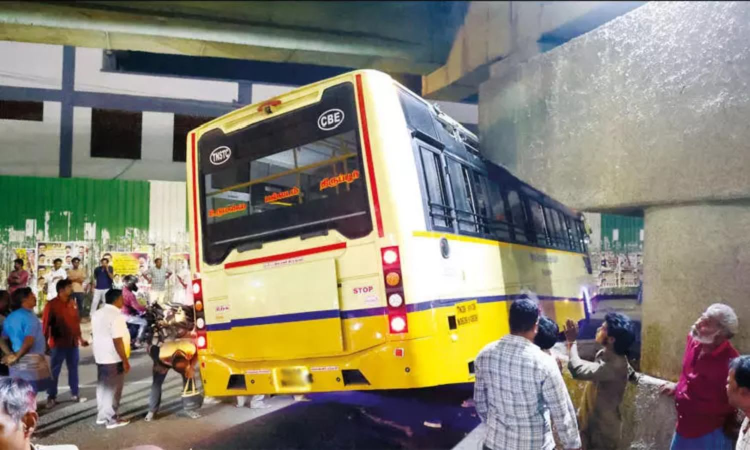 Government bus gets stuck under flyover pillar in Tirupur; traffic hit for 30 minutes