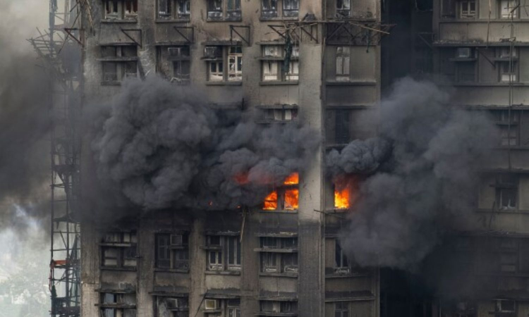At least 65 dead as Hong Kong firefighters battle burning towers for second day
