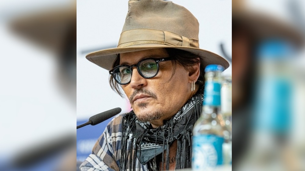 Johnny Depp looks disheveled as hes escorted out of hotel