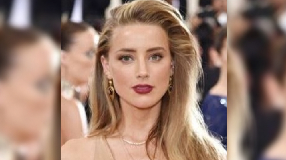 Amber lashes out a social media, but says Depp is a beloved character