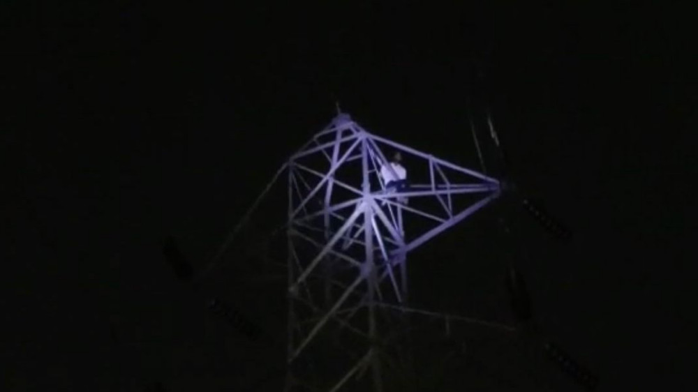 Watch: Man atop EB tower threatens to end life, thrashed by public