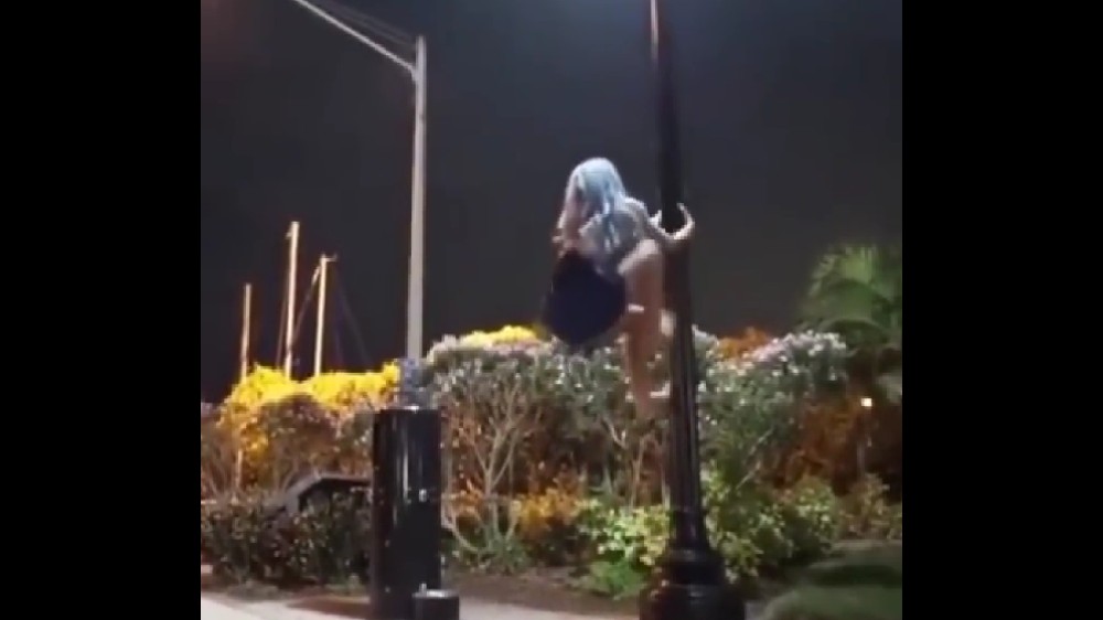 Watch: Woman performs dangerous aerobics on lamp post