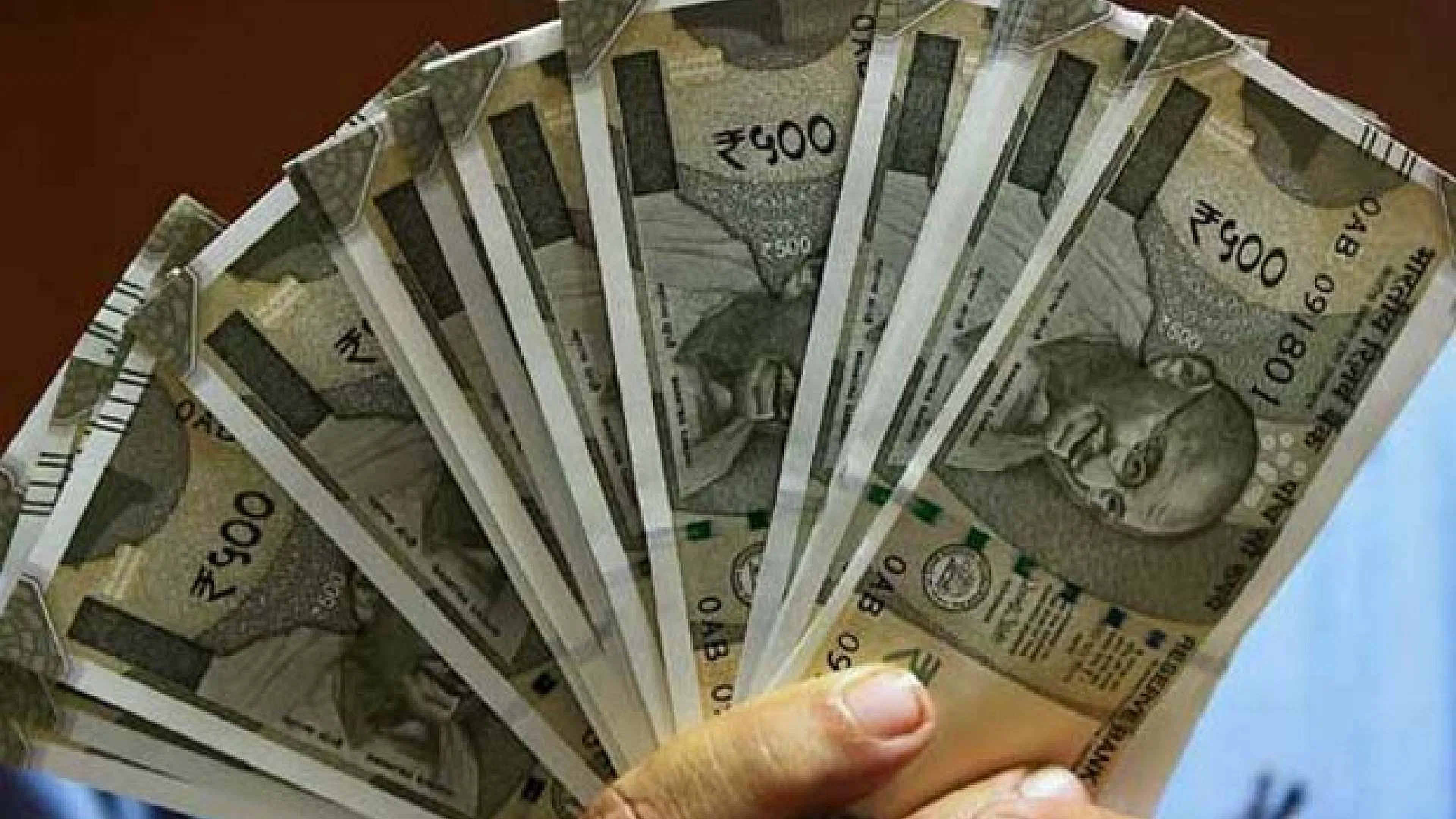 Rupee touches 82.72 against dollar before closing at 82.63