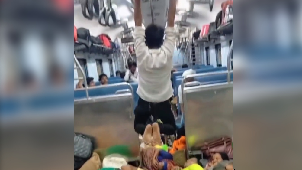Viral video: ‘Spiderman’ swings on handrail inside local train Viral video: ‘Spiderman’ swings on handrail inside local train