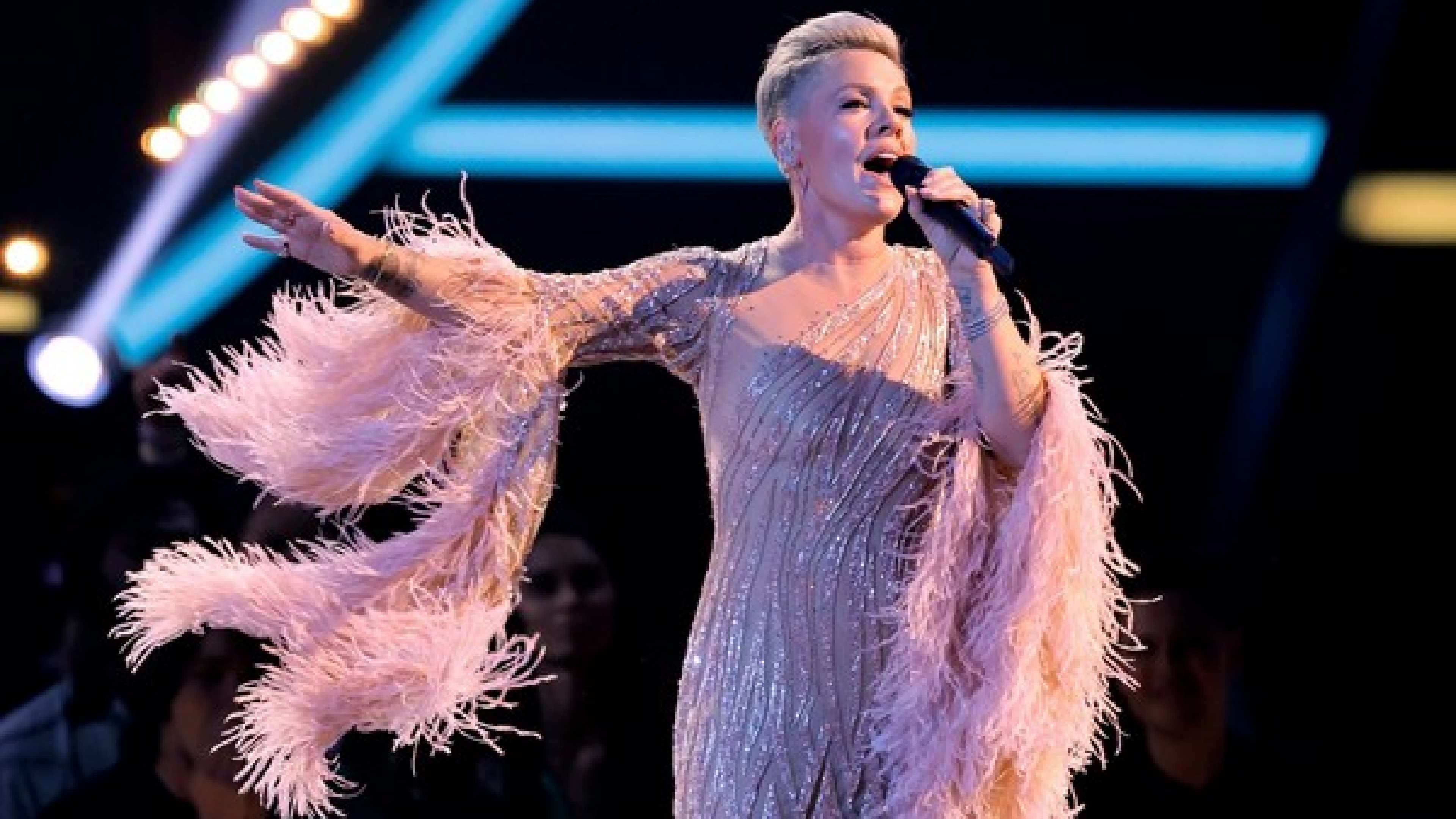 Pink honours late Grease star with performance at AMAs
