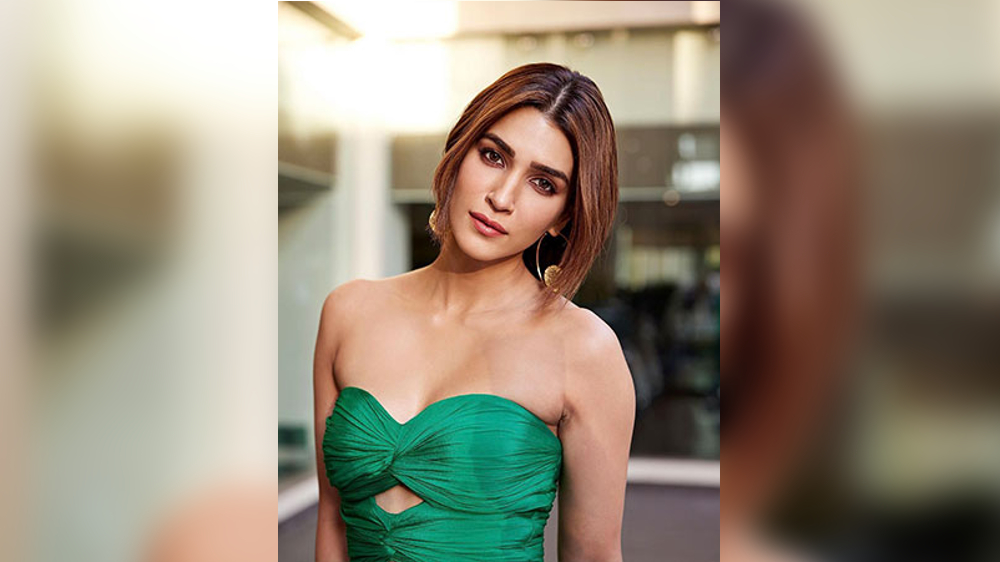 Kriti exudes bond girl-vibe in copper thigh-high leg slit dress