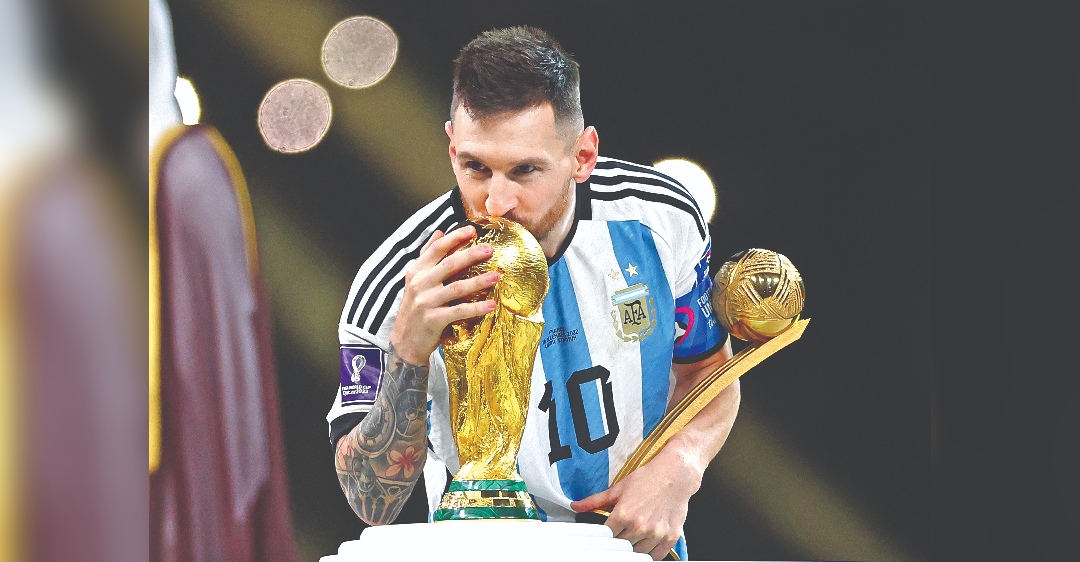 World at his feet, cup in his hands