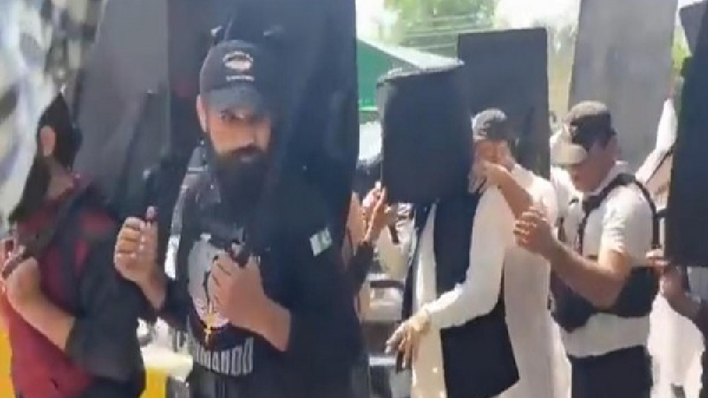 Imran Khan walks into court with bulletproof helmet, human shields