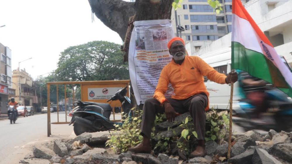 Activist stages dharna to save tree with a banner in Pattalam