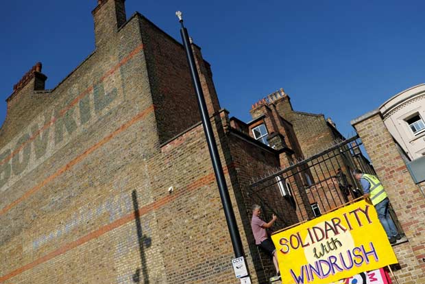 Britain apologises to migrants removed in Windrush scandal
