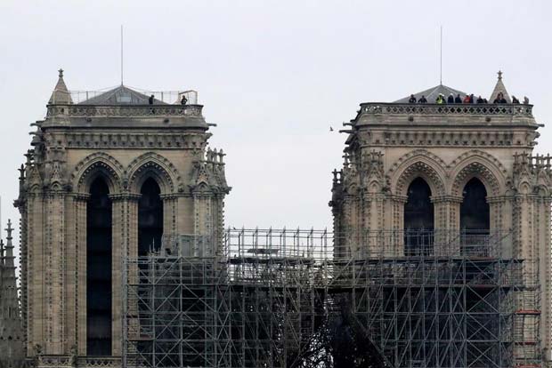 Workers questioned over Notre-Dame inferno as donations pour in