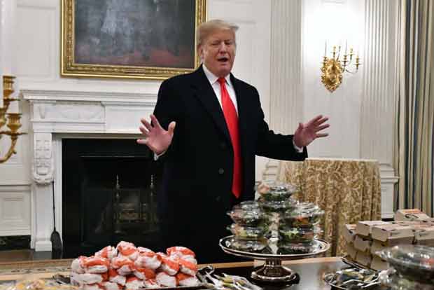 Burgers by candlelight: Trump lays out fast food for college football champs