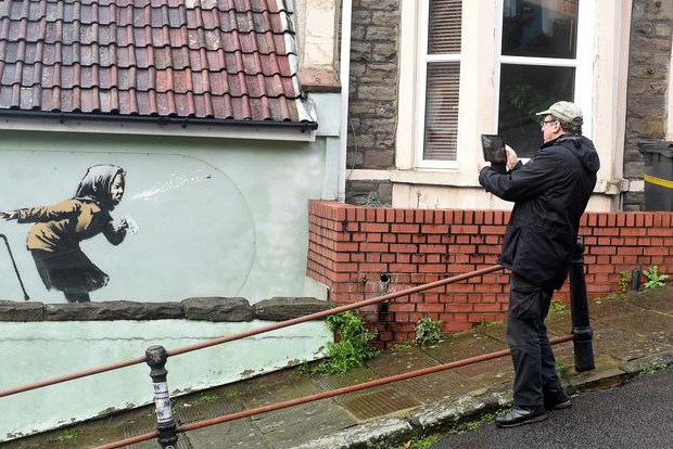 Banksy mural of sneezing woman appears on Englands steepest street Banksy mural of sneezing woman appears on Englands steepest street