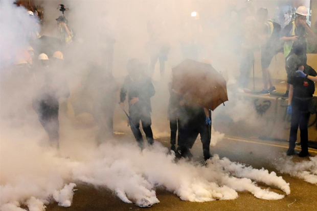 Tear gas fired as Hong Kong protesters block roads
