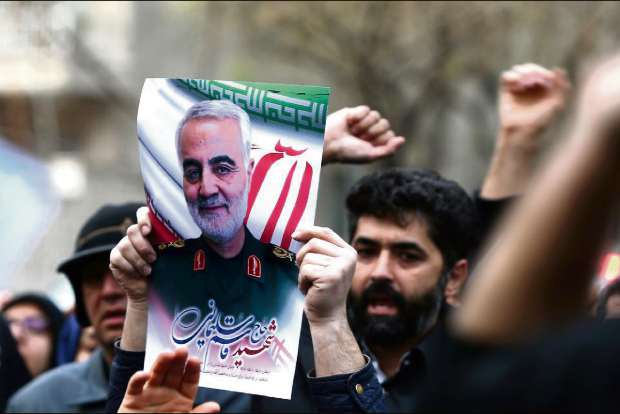 US flags burn as thousands mourn general in Tehran