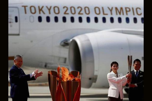 Japan welcomes Olympic flame as doubts swirl over Games