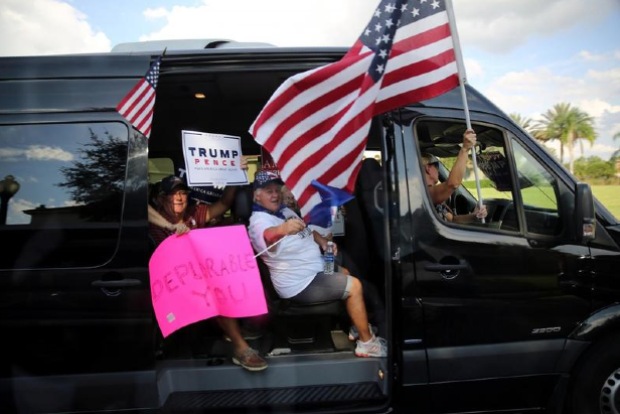 Trump thrills protesting supporters with motorcade drive-by