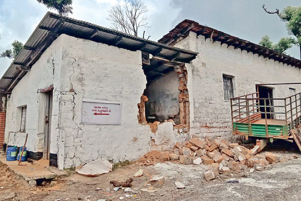 Elephant herd damages a portion of building in Valparai tea estate
