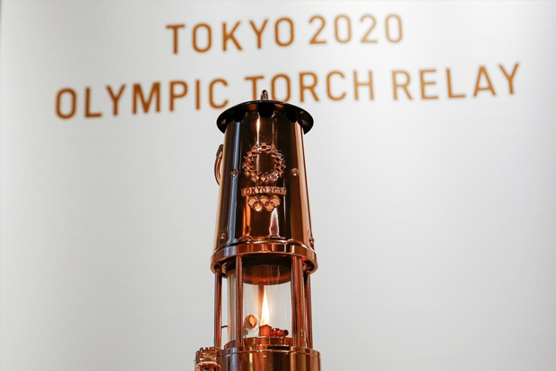 Olympics flame goes on display at a low-key ceremony