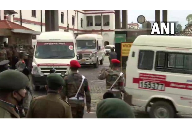 People shower flowers on ambulances carrying bodies of chopper crash victims