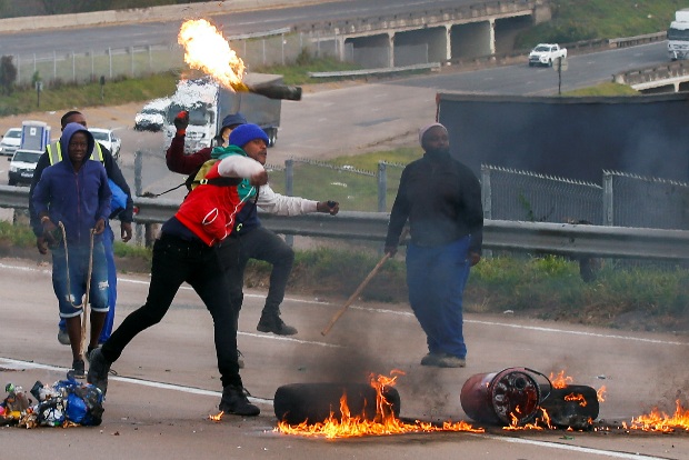 South African police arrest 62 after violent protests