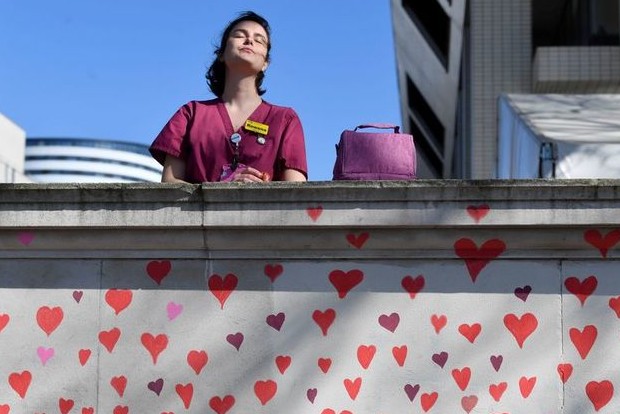 Mourners start drawing almost 150,000 hearts in London to remember COVID victims