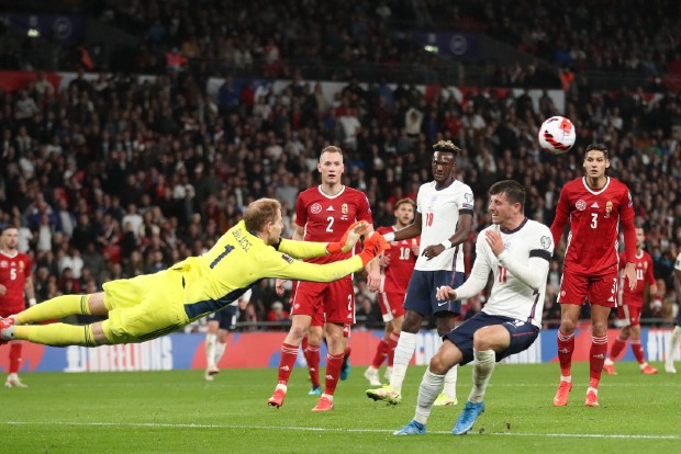 Soccer-England held 1-1 by Hungary in match marred by crowd violence