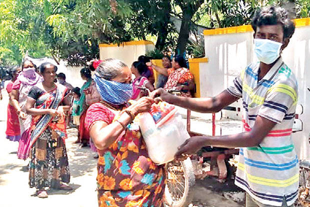 NGO distributes flood relief kits to Irula tribal families