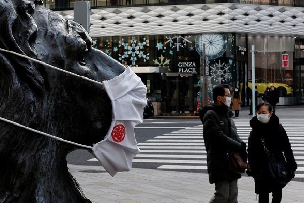 Japan steps up anti-Covid measures amid record rise in cases