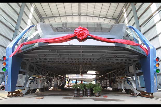 Futuristic street-straddling bus gets test run